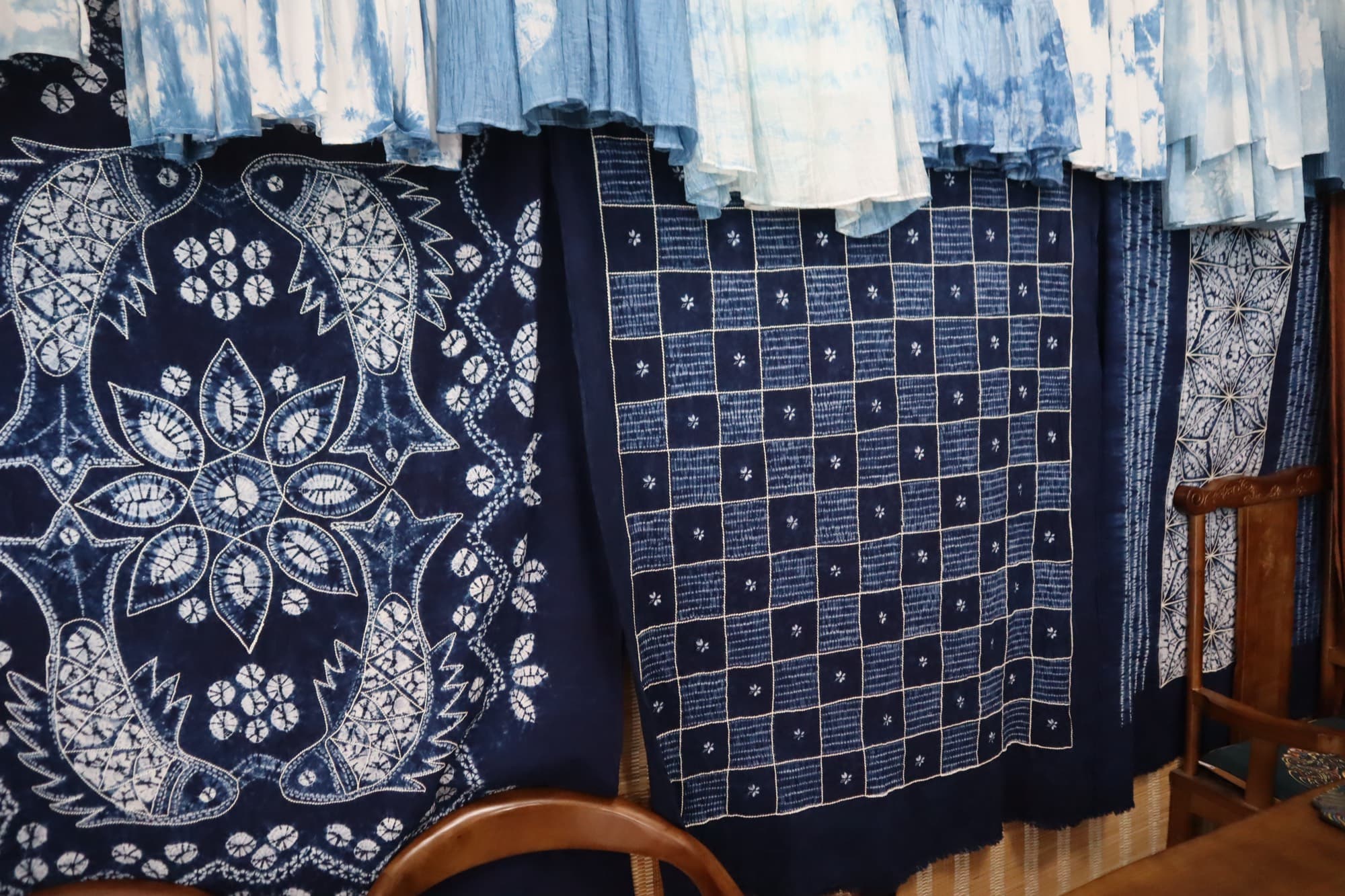 Hand-dyed indigo cloth hanging in the Zhoucheng workshop