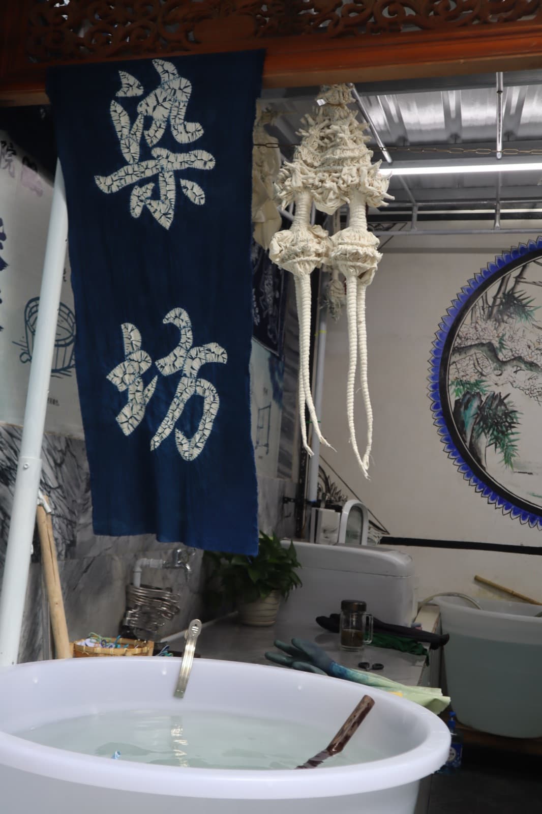 A tied bundle of cloth hanging in the dye house before dyeing