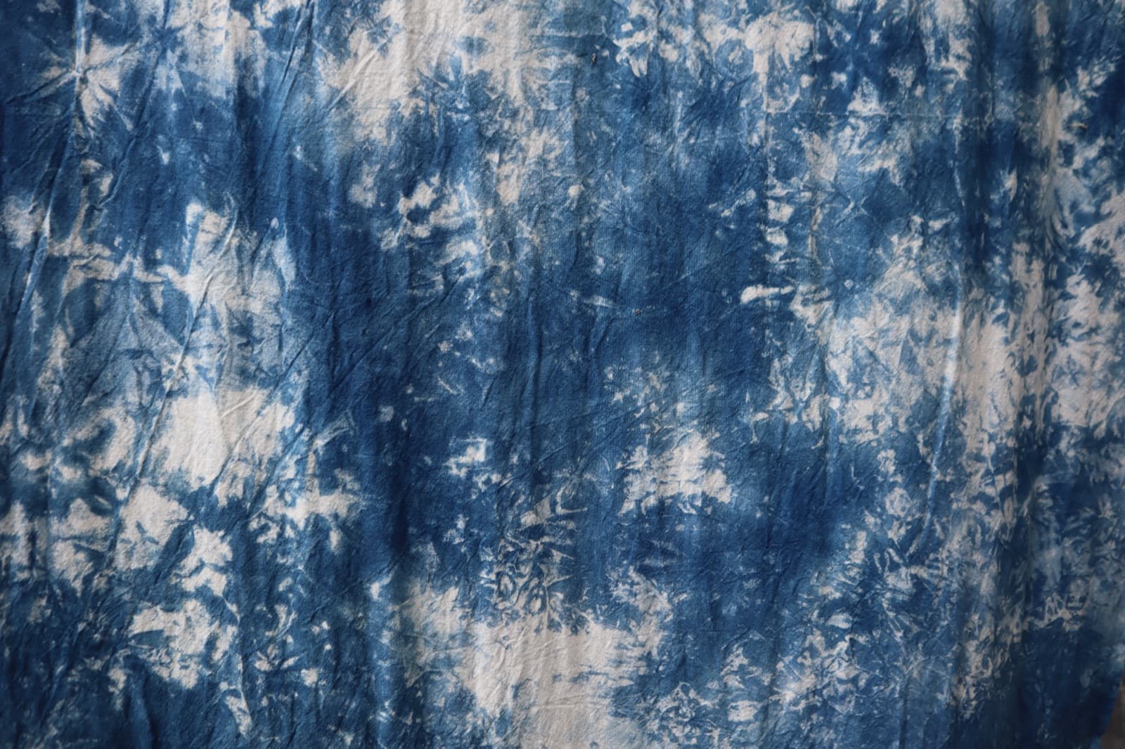 Indigo and white tie-dyed cloth, like pieces of sky.